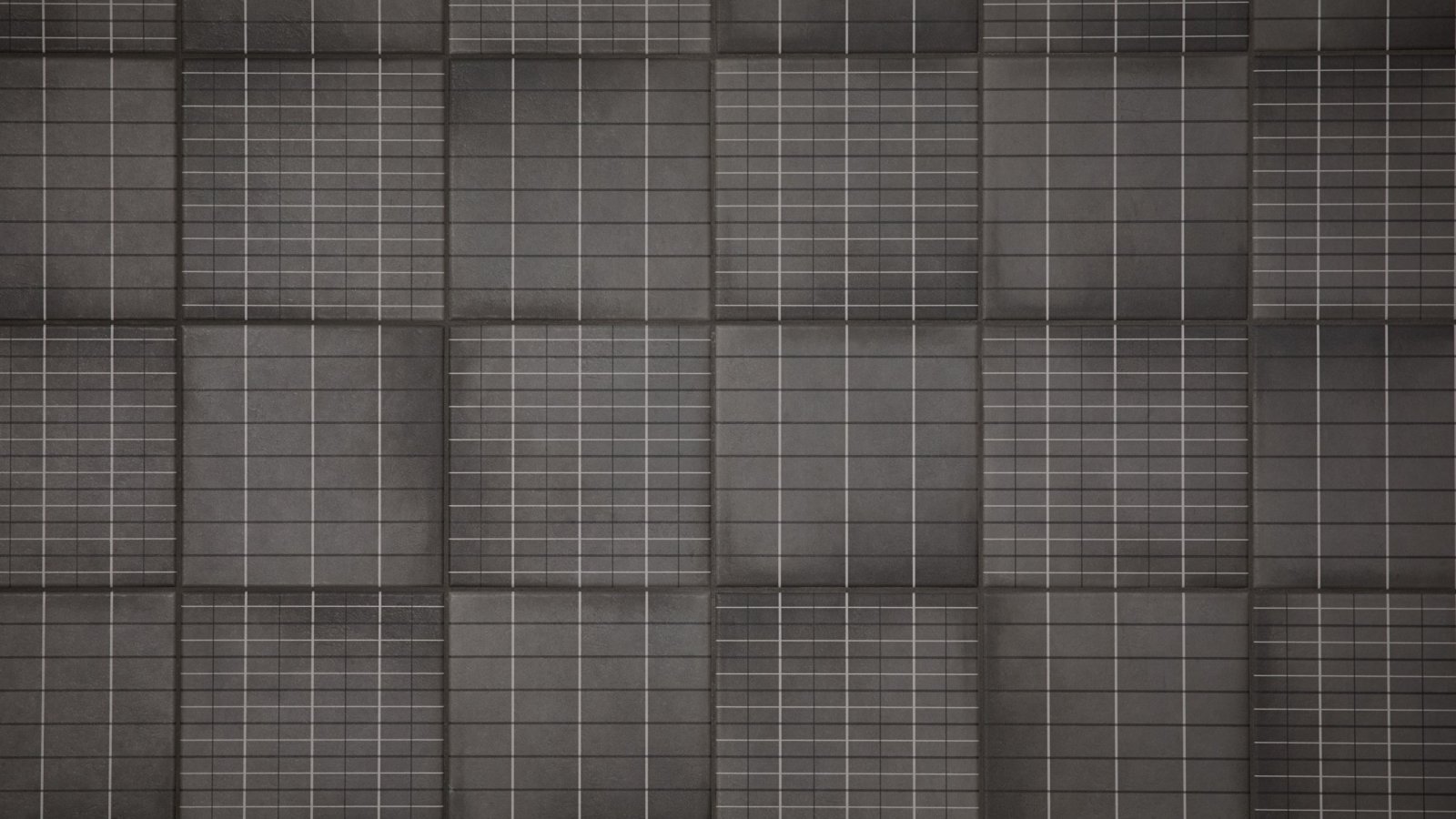 Parete bagno in gres Aurore Charcoal Grid L di Mutina con posa a scacchiera