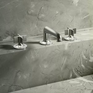Lavabo a parete Flora di Fantini in finitura Mokka su rivestimento in pietra